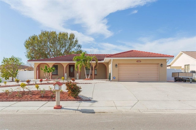 mediterranean / spanish home with a garage