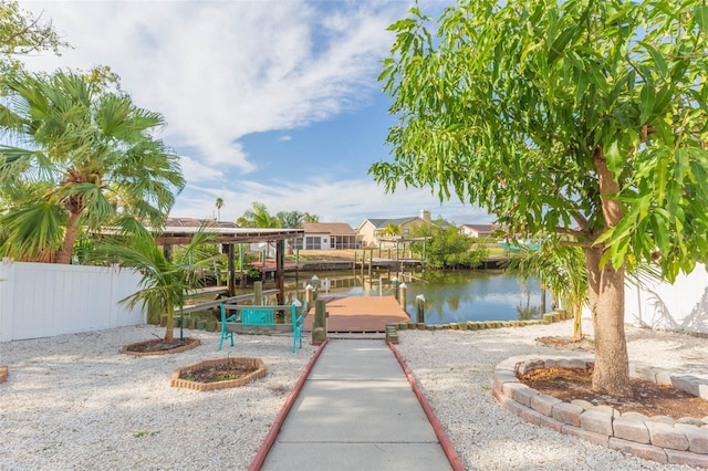 view of patio with a water view and a dock