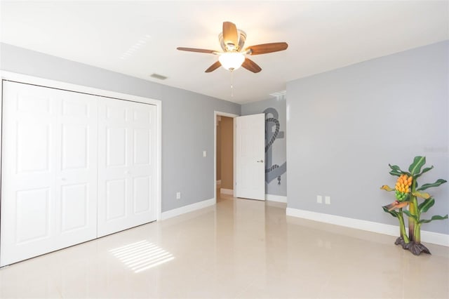 unfurnished bedroom featuring ceiling fan, light tile patterned floors, and a closet