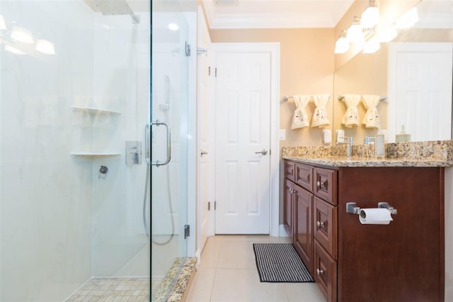 bathroom with tile patterned floors, crown molding, vanity, and an enclosed shower