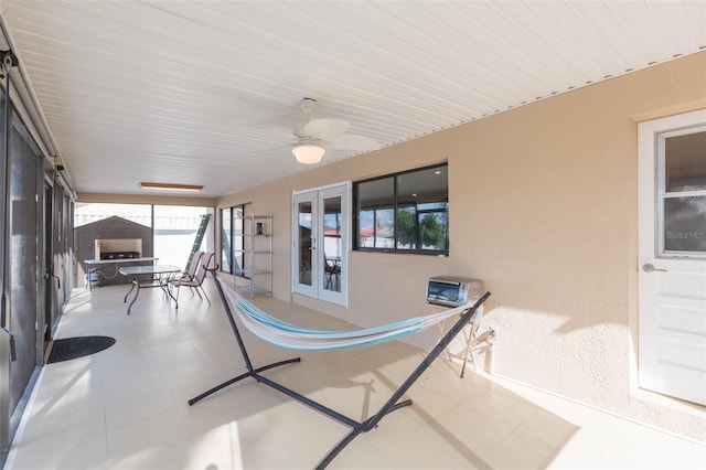 sunroom / solarium with french doors and ceiling fan