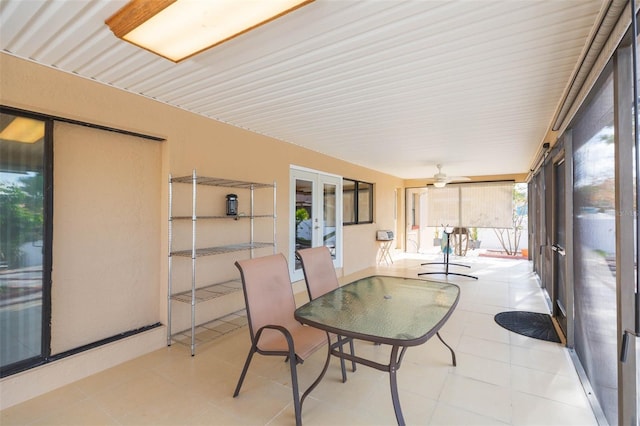 sunroom / solarium with ceiling fan and french doors