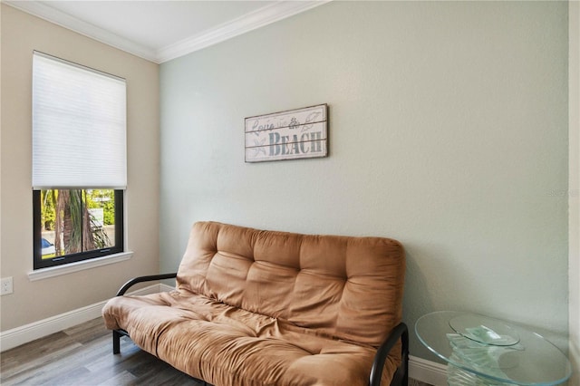 living area with hardwood / wood-style flooring and ornamental molding