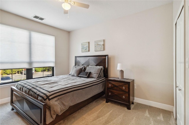 carpeted bedroom featuring a closet and ceiling fan