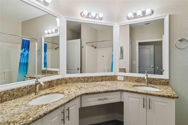 bathroom featuring a shower with shower curtain and vanity