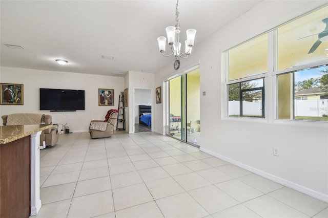 tiled living room featuring a notable chandelier