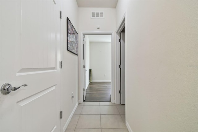 corridor featuring light tile patterned flooring