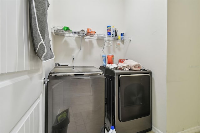 washroom with independent washer and dryer