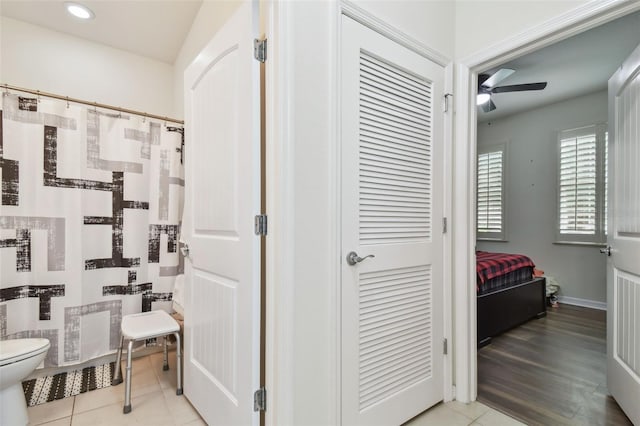 bathroom with hardwood / wood-style flooring, toilet, and ceiling fan