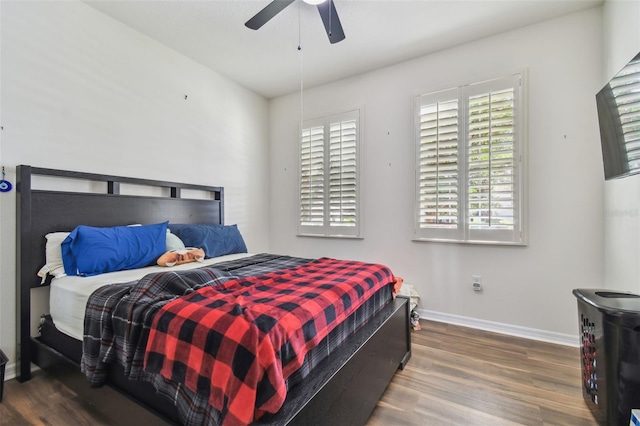 bedroom with ceiling fan and dark wood-type flooring