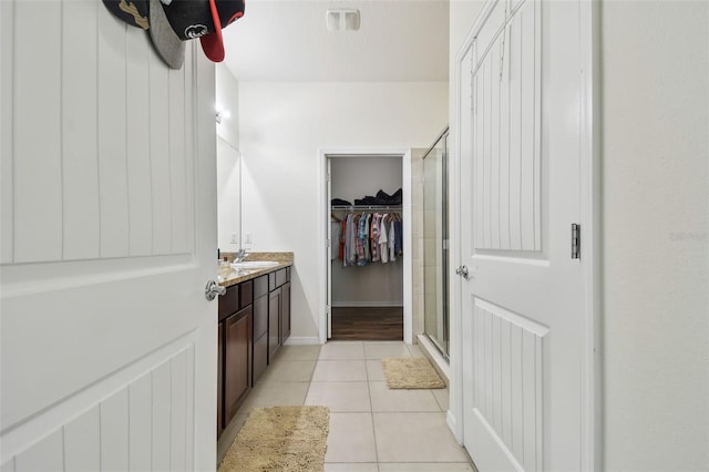 bathroom featuring tile patterned floors, vanity, and walk in shower