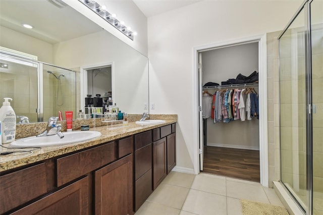 bathroom featuring hardwood / wood-style flooring, vanity, and a shower with door