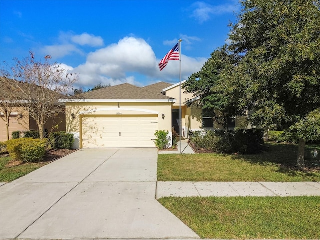 view of front of home with a front lawn and a garage