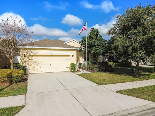 view of front of house featuring a garage and a front lawn