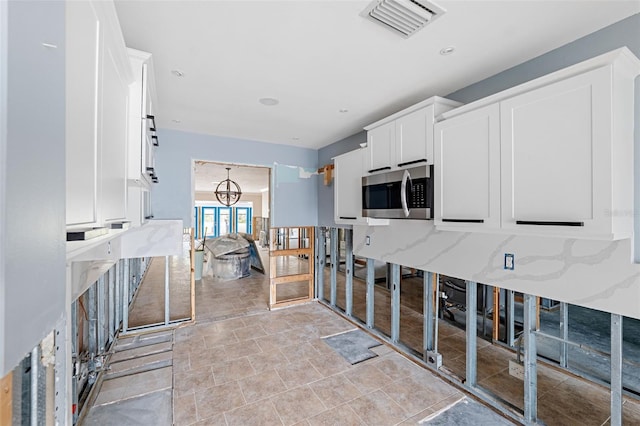 kitchen featuring white cabinets and french doors