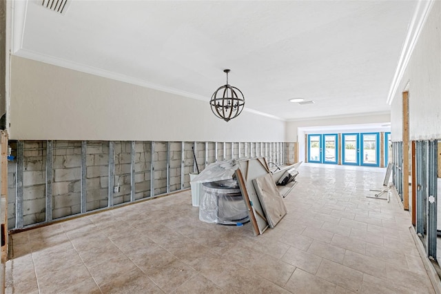 interior space with crown molding and an inviting chandelier