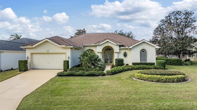 view of front of house with french doors, a front lawn, and a garage