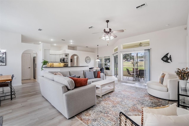 living room featuring ceiling fan and light hardwood / wood-style floors