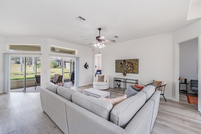 living room featuring light hardwood / wood-style floors and ceiling fan