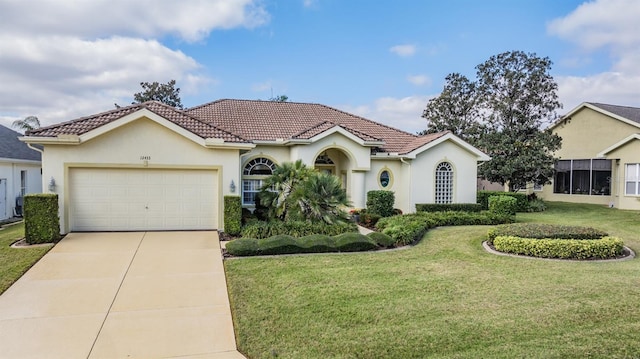 view of front of home with a garage and a front lawn