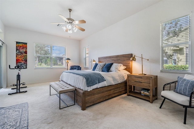 bedroom with ceiling fan and light colored carpet