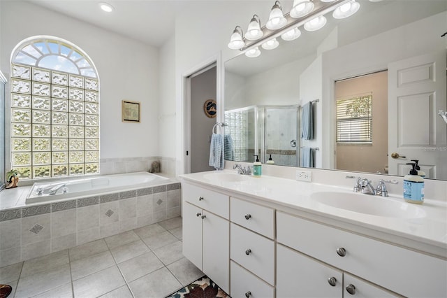 bathroom featuring tile patterned flooring, shower with separate bathtub, vanity, and plenty of natural light