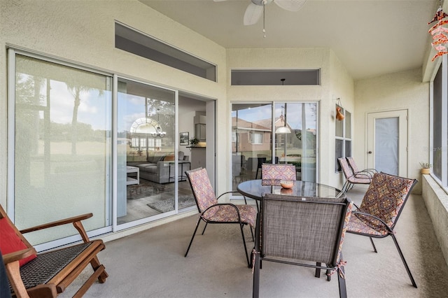 sunroom / solarium with plenty of natural light and ceiling fan