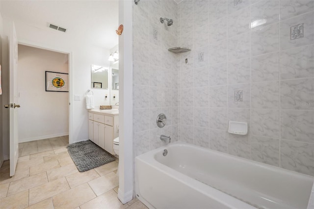 full bathroom with tile patterned floors, vanity, toilet, and tiled shower / bath combo