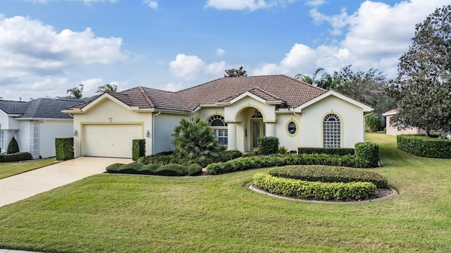 view of front of house with a garage and a front lawn