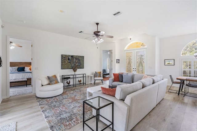 living room featuring ceiling fan and light hardwood / wood-style flooring