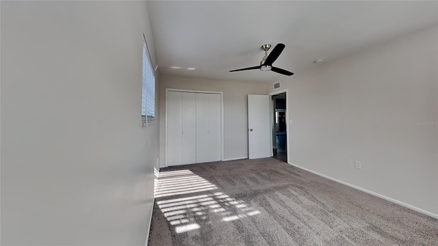 unfurnished bedroom with carpet flooring, a closet, and ceiling fan