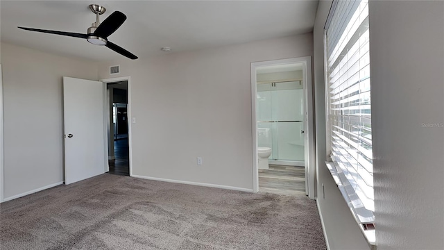 unfurnished bedroom featuring light carpet, ceiling fan, and ensuite bathroom