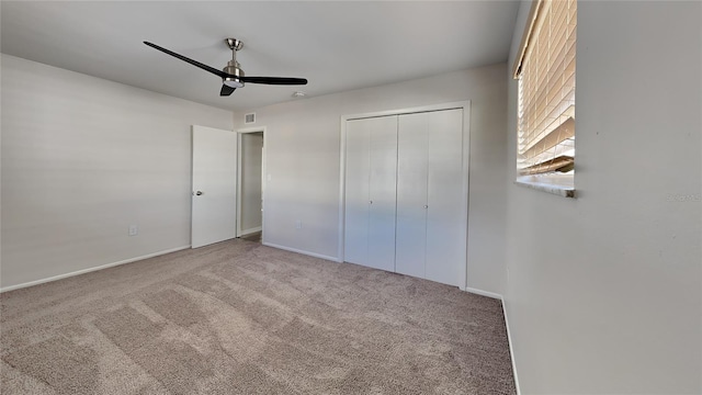 unfurnished bedroom with ceiling fan, a closet, and carpet floors