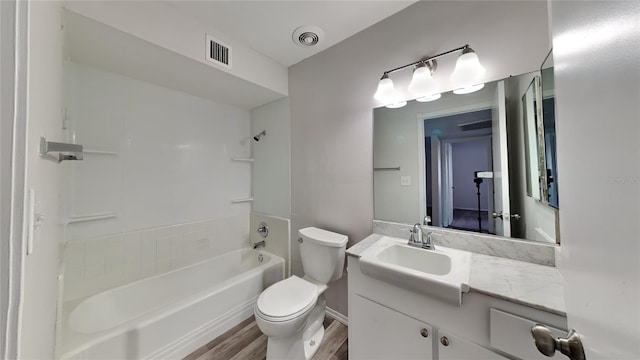 full bathroom featuring bathing tub / shower combination, hardwood / wood-style flooring, vanity, and toilet