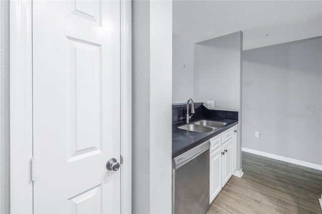 501 Knights Run Ave Unit 2308, Tampa, FL 33602 - kitchen with dishwasher, light wood-type flooring, white cabinets, and sink