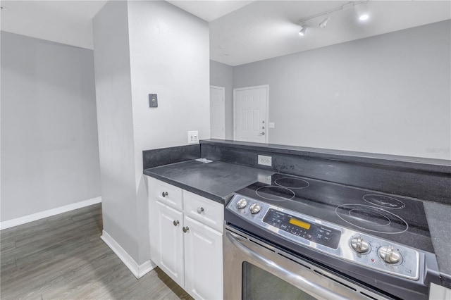 501 Knights Run Ave Unit 2308, Tampa, FL 33602 - kitchen featuring white cabinetry, stainless steel range with electric cooktop, and wood-type flooring