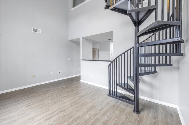 501 Knights Run Ave Unit 2308, Tampa, FL 33602 - staircase with hardwood / wood-style flooring and a high ceiling