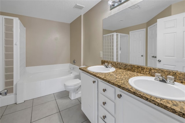 501 Knights Run Ave Unit 2308, Tampa, FL 33602 - bathroom featuring a bathtub, vanity, tile patterned flooring, toilet, and a textured ceiling