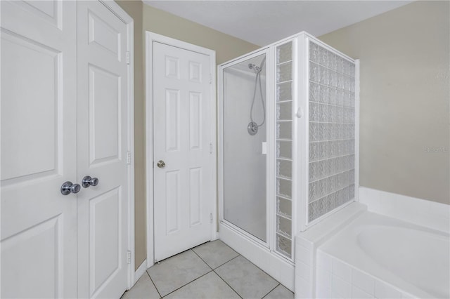 501 Knights Run Ave Unit 2308, Tampa, FL 33602 - bathroom featuring tile patterned flooring and shower with separate bathtub