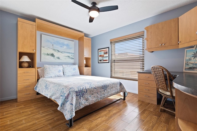 bedroom featuring dark hardwood / wood-style floors and ceiling fan