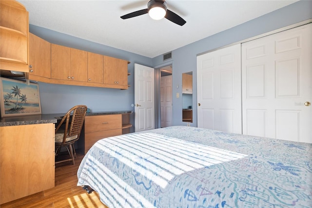 bedroom with ceiling fan, a closet, and light hardwood / wood-style flooring