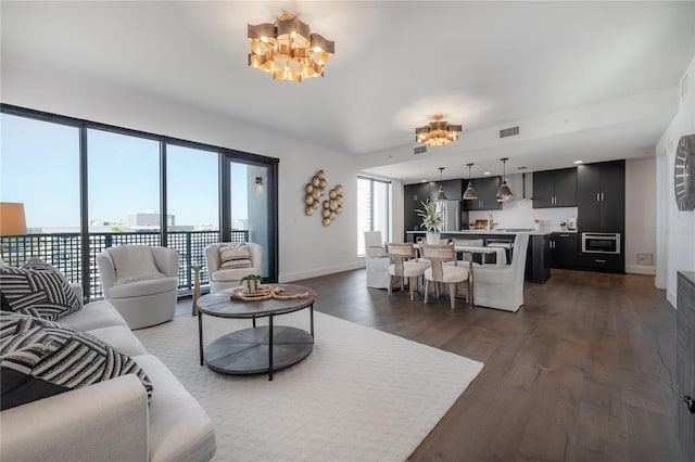 living room featuring dark hardwood / wood-style flooring and a notable chandelier