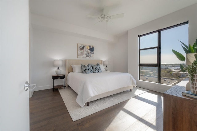 bedroom with ceiling fan and dark wood-type flooring