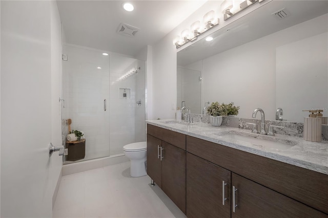 bathroom with tile patterned floors, vanity, toilet, and an enclosed shower