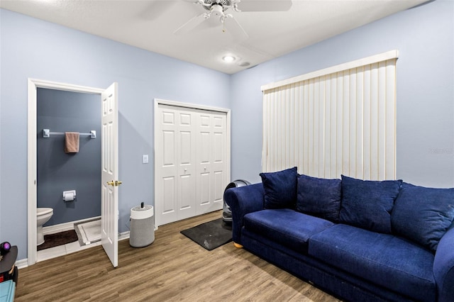 living room featuring ceiling fan and hardwood / wood-style flooring