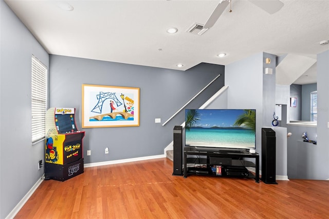 miscellaneous room with hardwood / wood-style floors, ceiling fan, and a healthy amount of sunlight