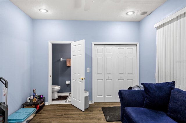 interior space featuring dark wood-type flooring and ceiling fan