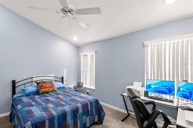 carpeted bedroom with ceiling fan and vaulted ceiling