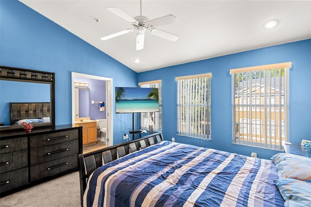 bedroom featuring lofted ceiling, ensuite bathroom, ceiling fan, and light colored carpet