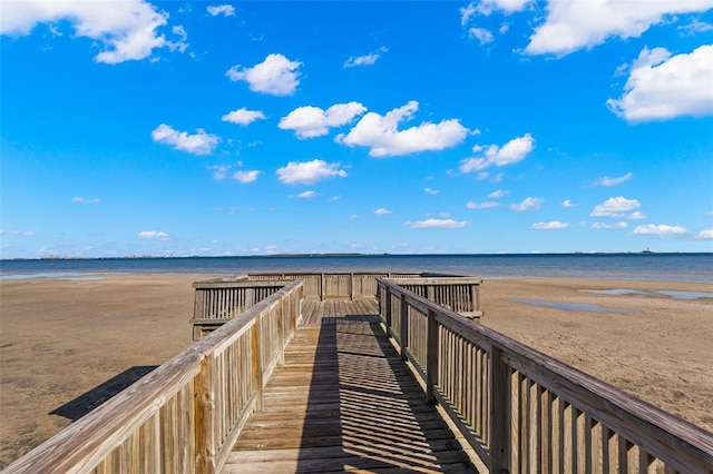 view of property's community with a beach view and a water view